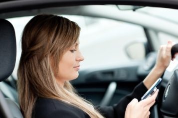 beautiful-businesswoman-sending-a-text-while-driving-2